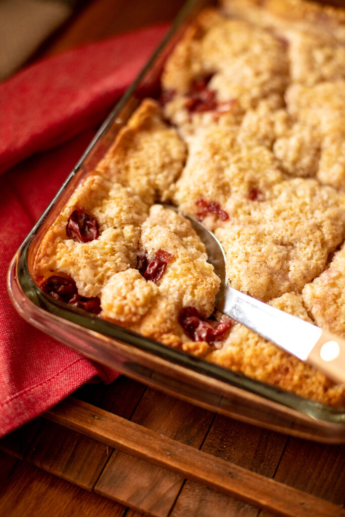 pan of cherry cake being served