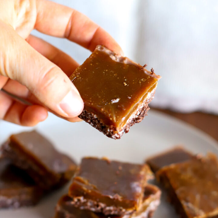 hand holding a slice of Homemade Toffee Chocolate Bars