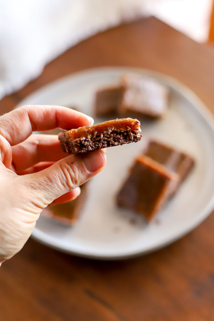 hand holding a slice of Homemade Toffee Chocolate Bars