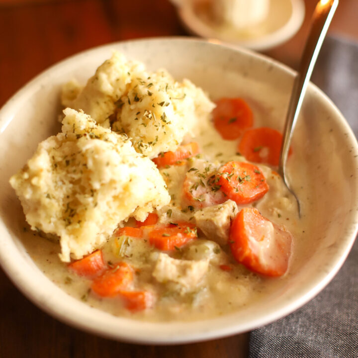 a bowl of chicken soup with dumplings
