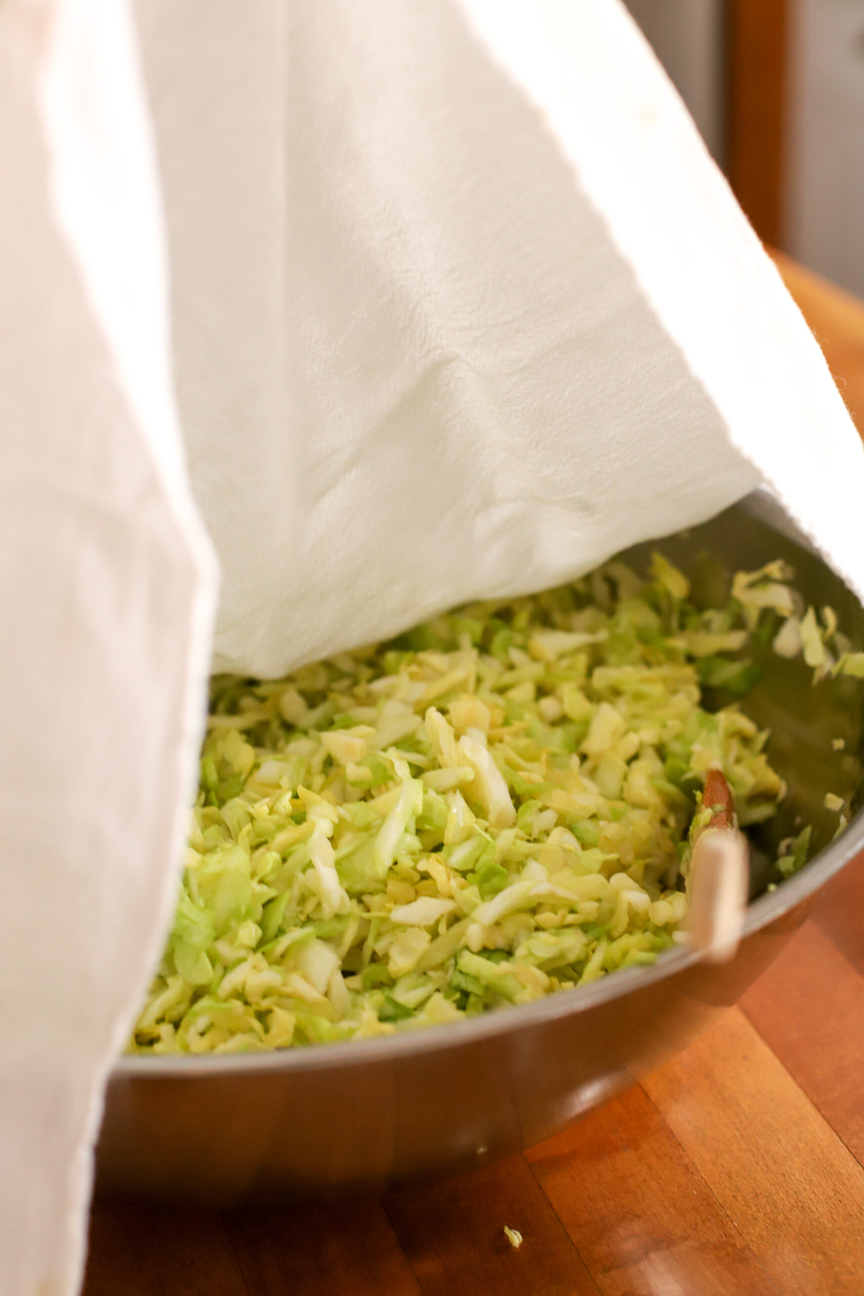 up close shot of homemade sauerkraut covered with a towel