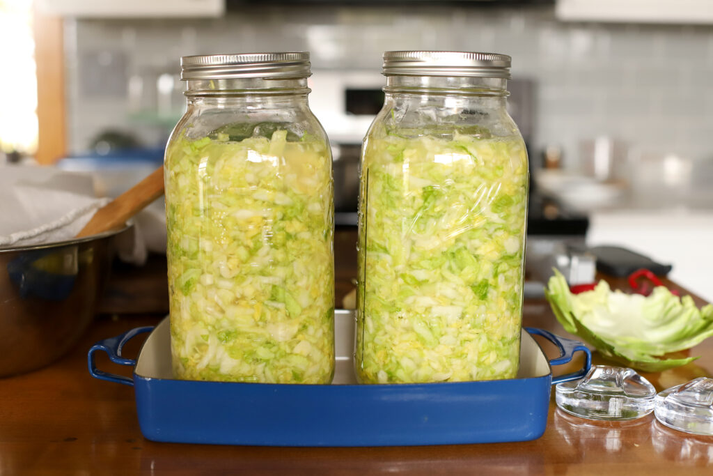 2 half gallon jars full of homemade sauerkraut