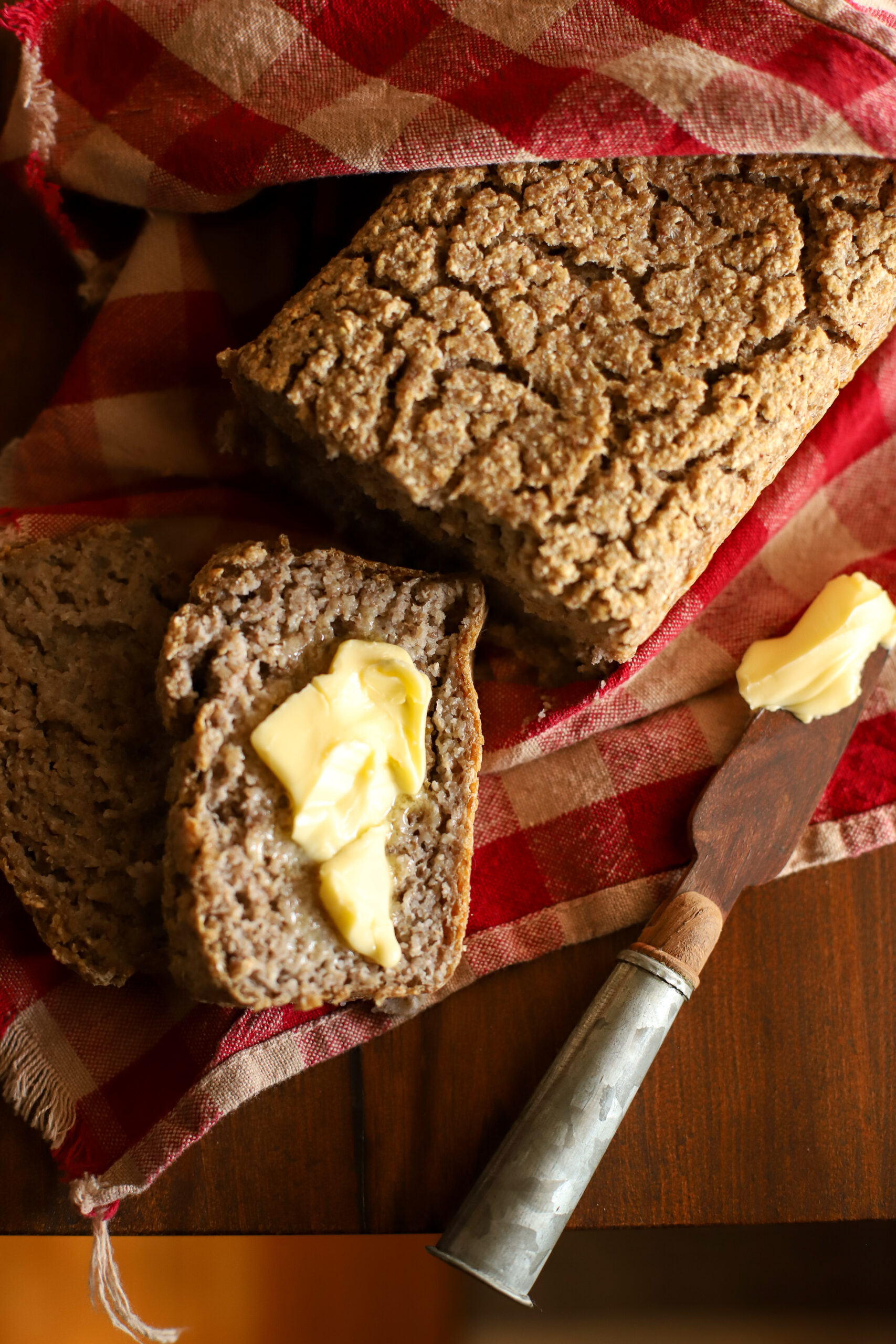 up close shot of slice of buckwheat bread slathered in butter