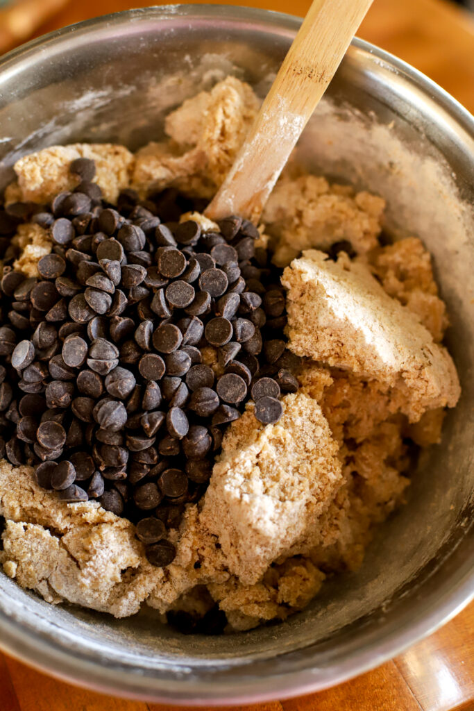 up close shot of cookie dough batter ready to mix in chocolate chips