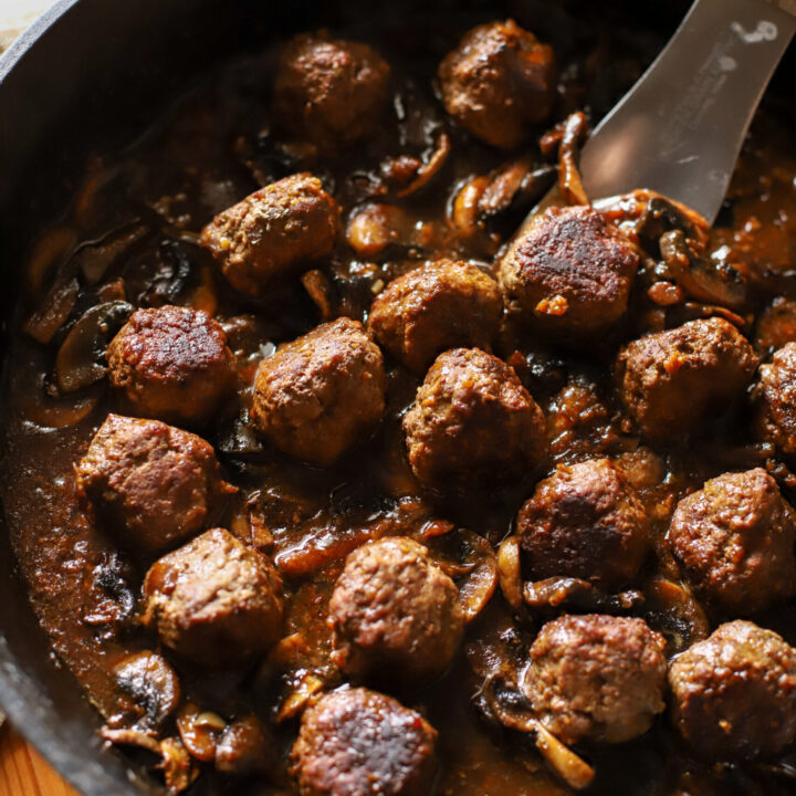 cast iron pan with meatballs and mushroom gravy