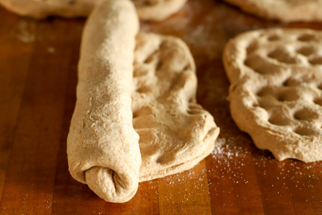 rolling sourdough sandwich bread into loaves