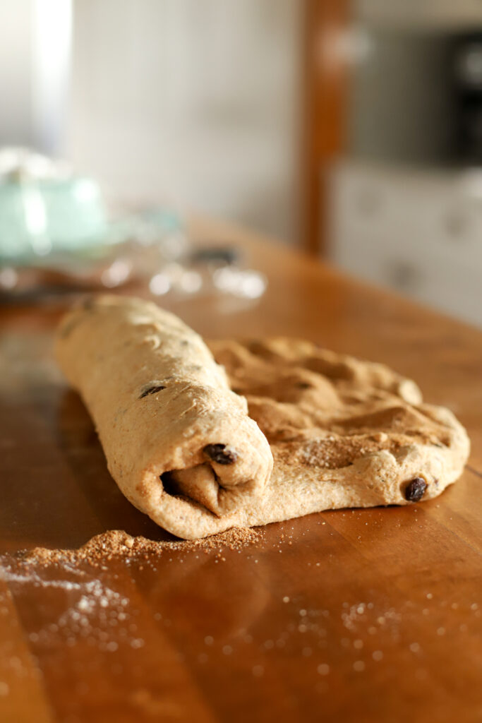rolling loaf of sourdough cinnamon raisin loaf