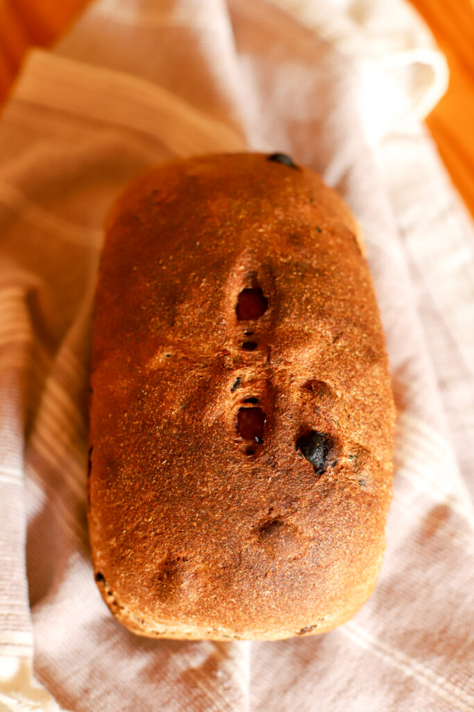 baked loaf of sourdough cinnamon raisin bread