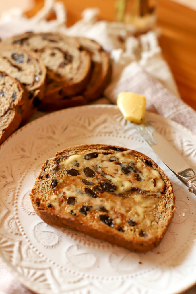 close up shot of buttered and toasted sourdough cinnamon raisin bread