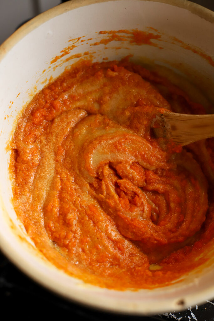 bowl of butter, sugar, and pumpkin puree mixed together