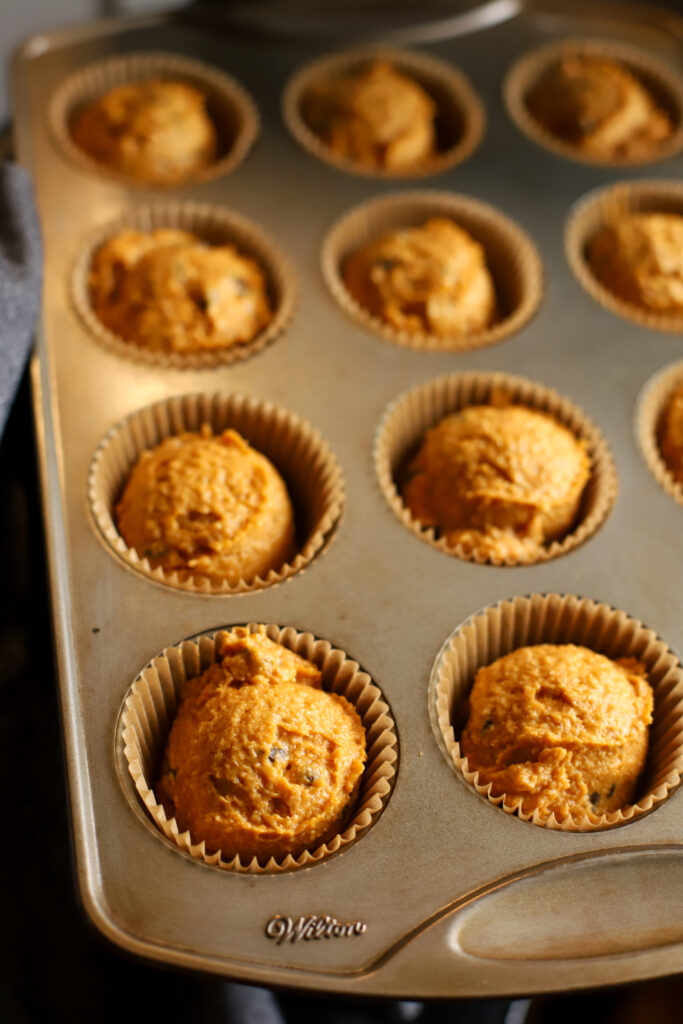 muffin pan filled with muffin batter ready to bake