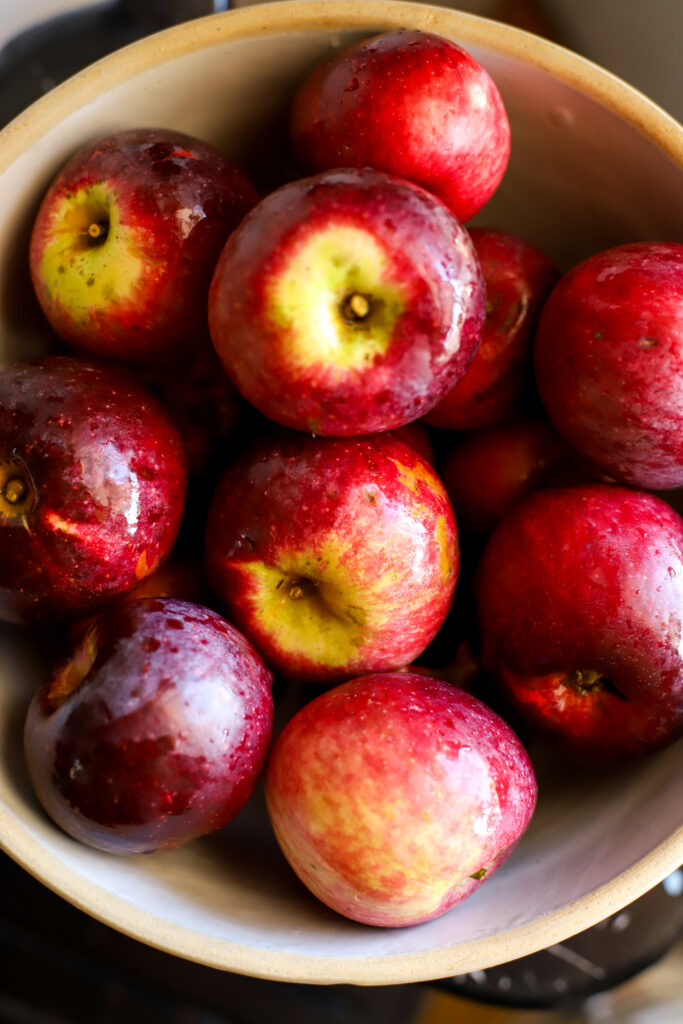 up close shot of freshly washed apples in a bowl