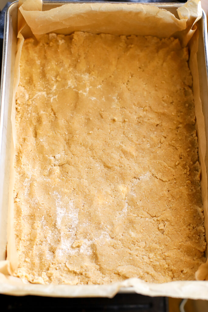 up close shot of shortbread crust pressed into pan