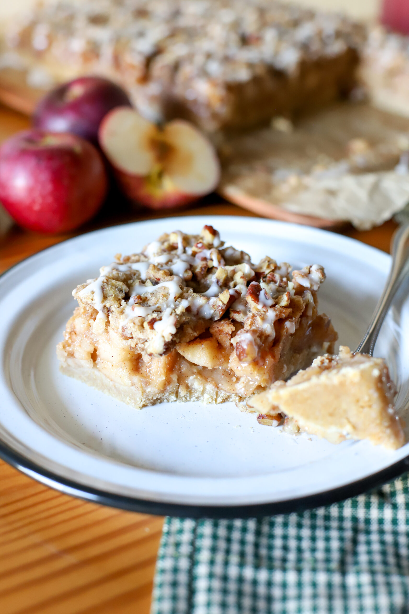 up close shot of apple pie bars on a plate with a bite taken out