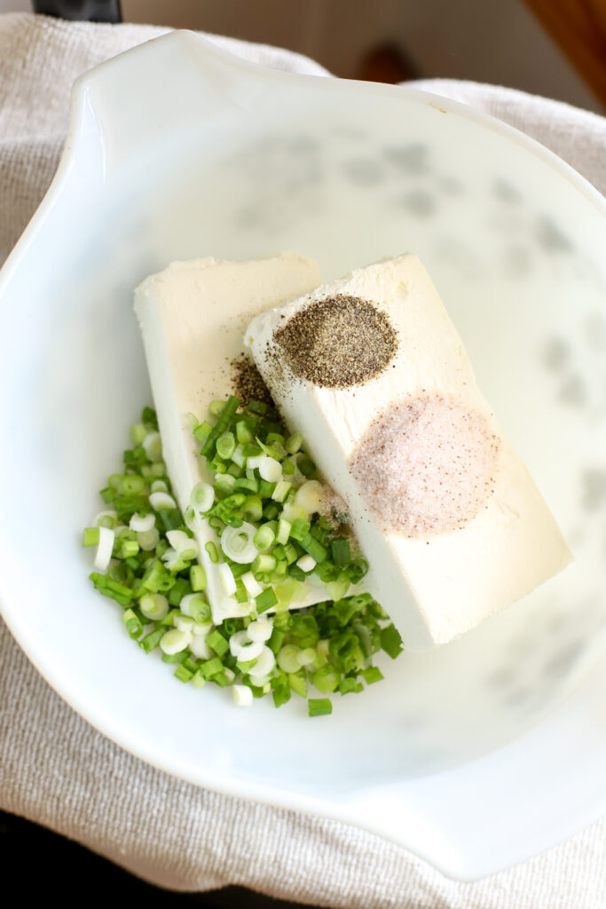 up close shot of all ingredients for cream cheese stuffed celery in a bowl ready to mix up
