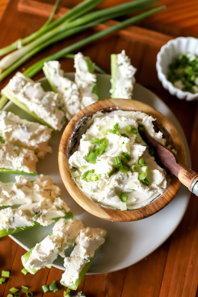 up close shot of cream cheese stuffed celery in a bowl