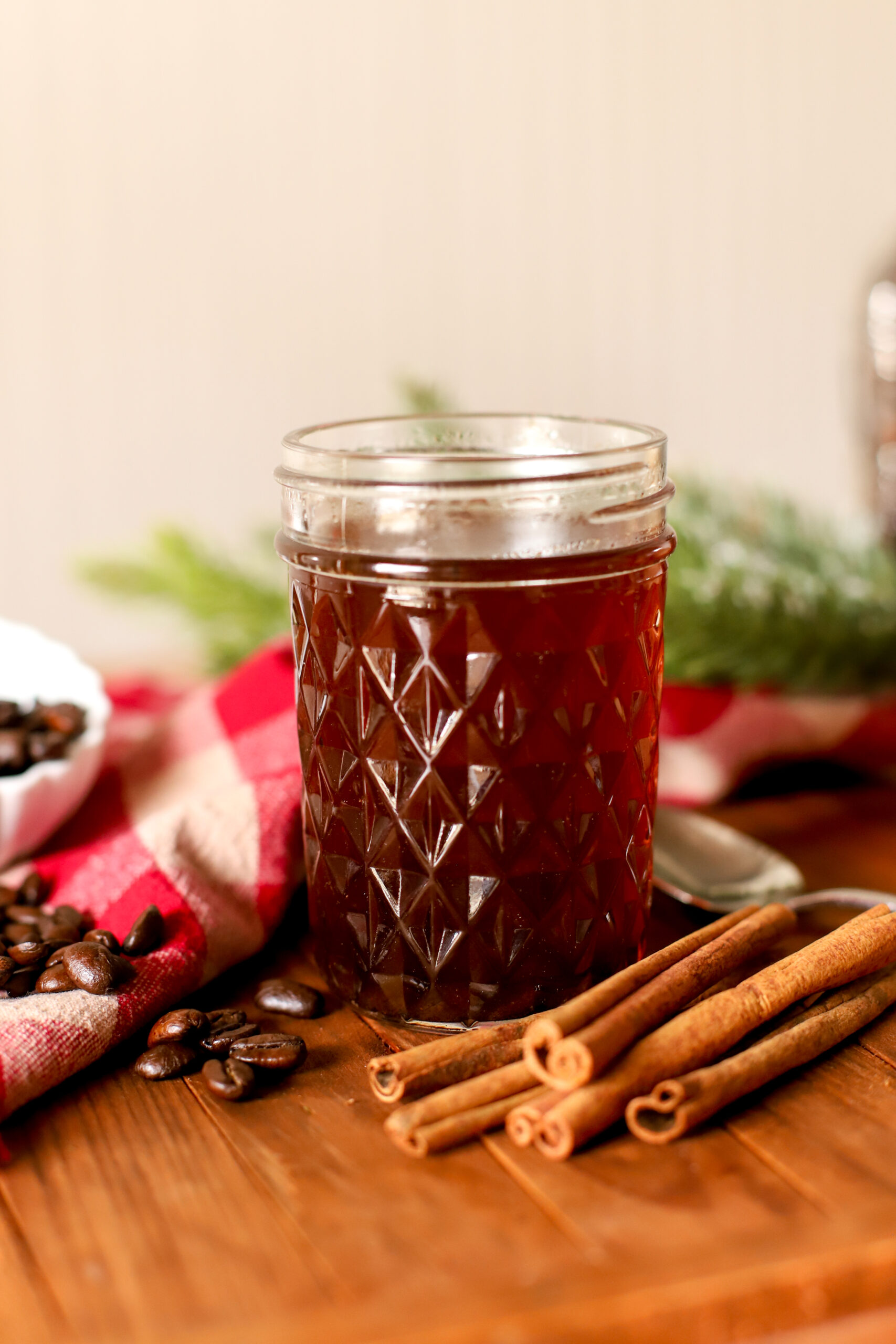 up close image of jar filled with maple cinnamon simple syrup