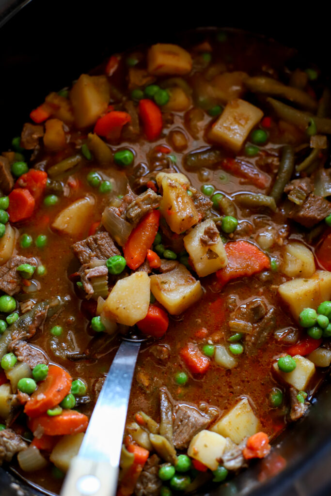 up close shot of scoop of crockpot vegetable beef soup