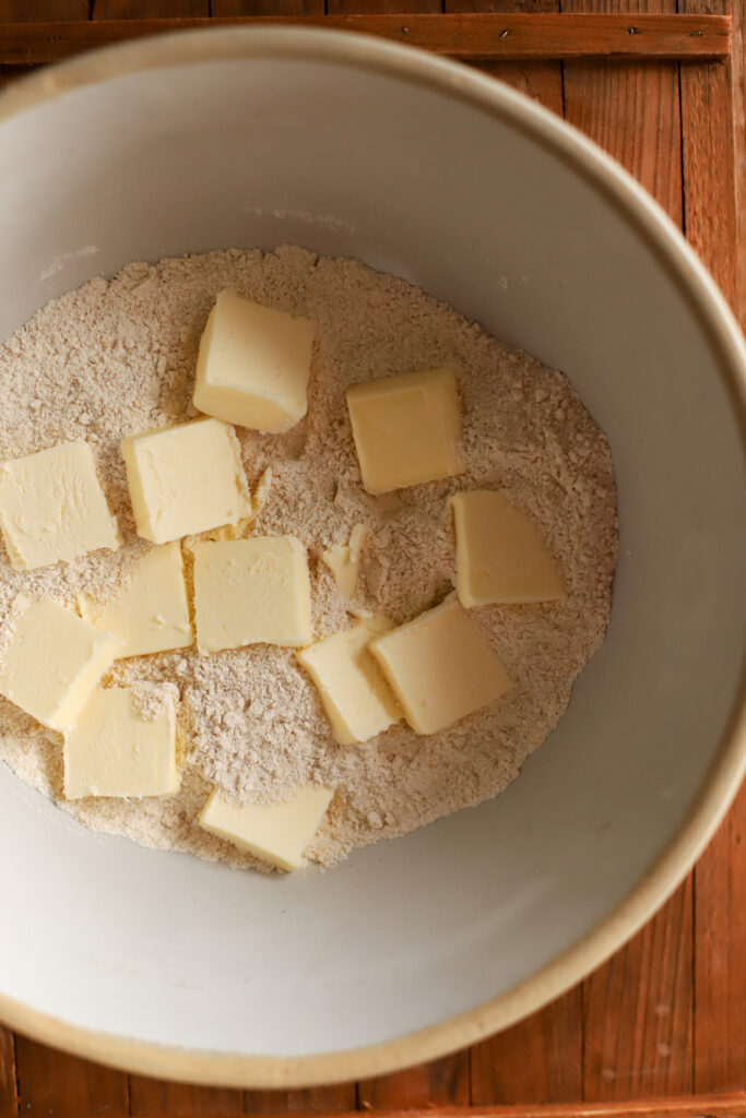 up close shot of flour and cubed butter in a bowl