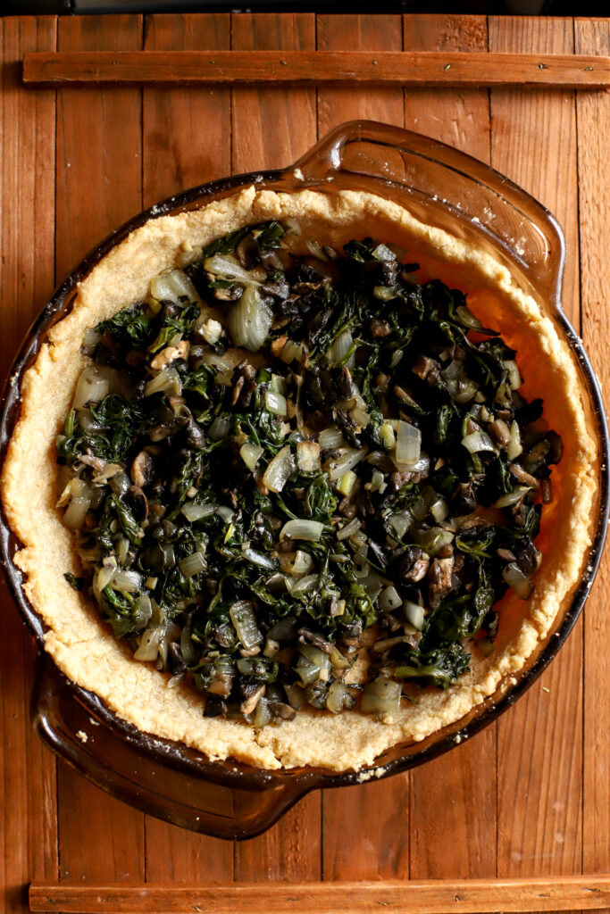 up close shot of sauteed vegetables in a pie crust