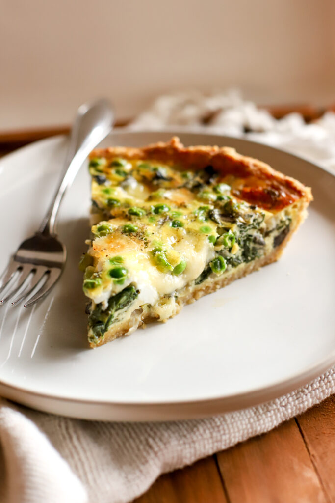 up close shot of slice of vegetable quiche with fresh milled crust