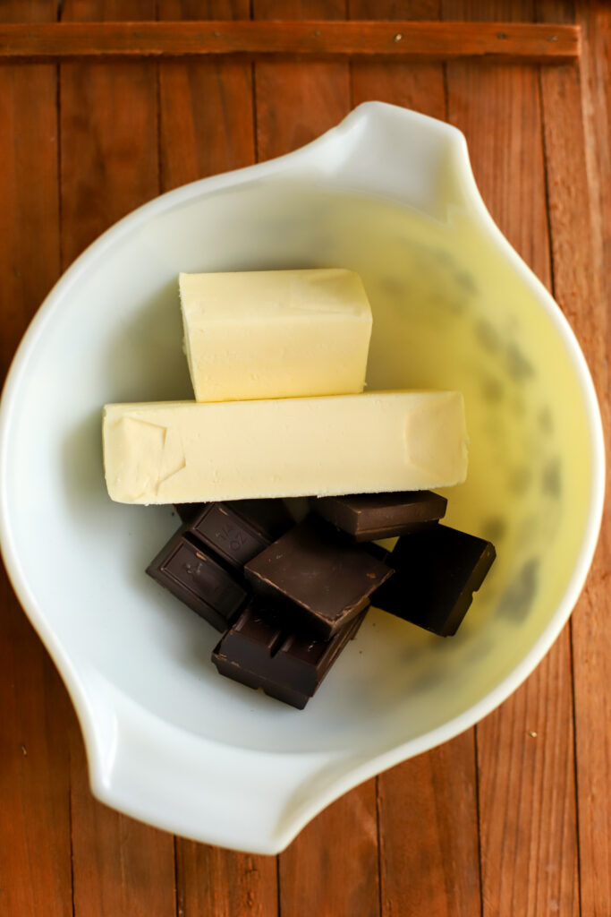 up close shot of unsweetened chocolate and butter in a bowl.