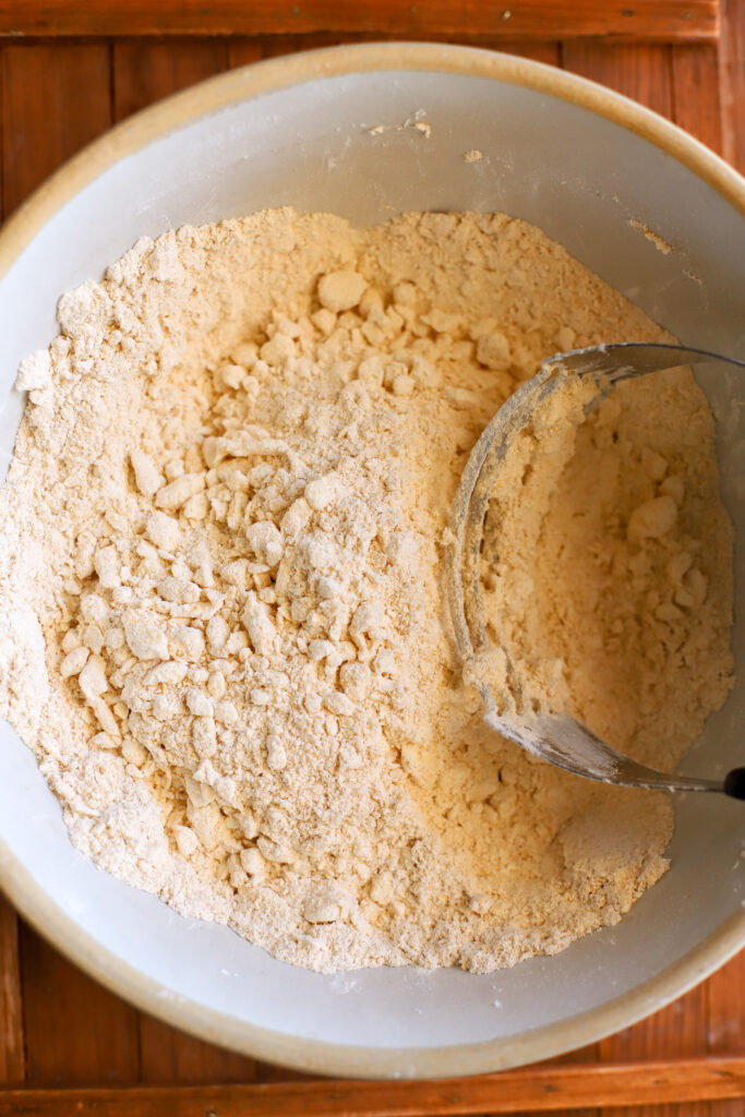 up close shot of butter cut into dry ingredients for biscuits with fresh milled flour