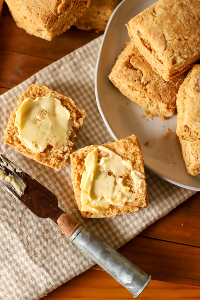 up close shot of fresh milled biscuit with butter on top