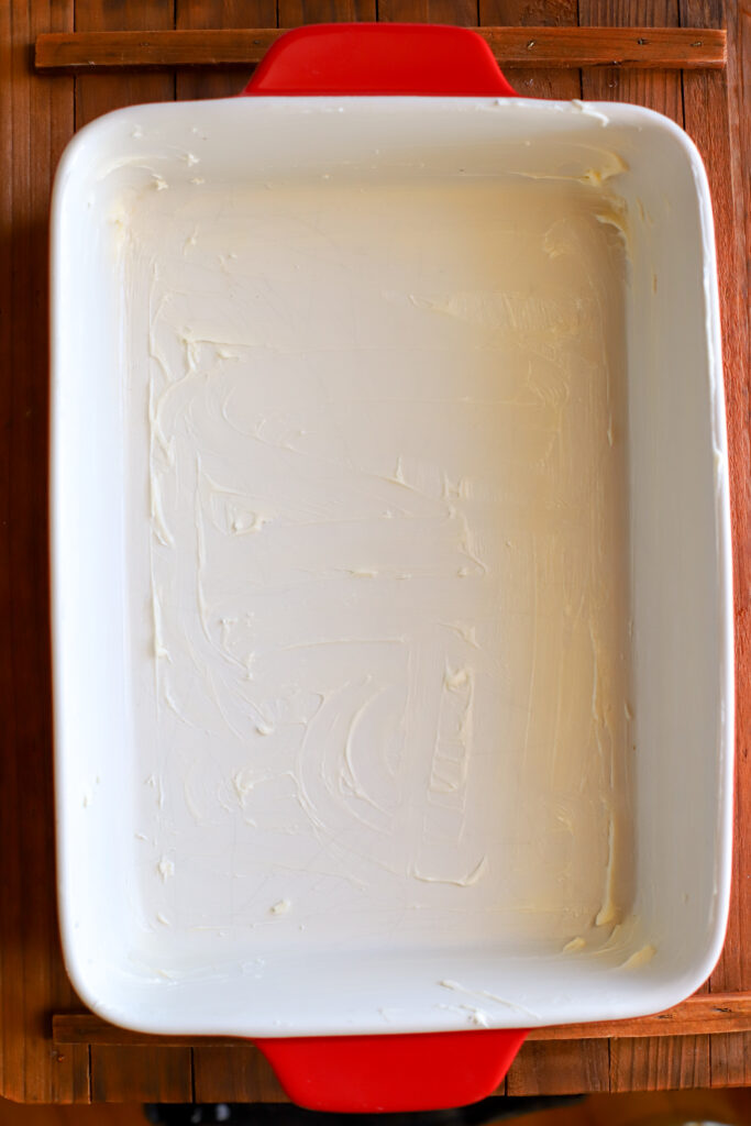 up close shot of 9x13 baking pan greased with butter