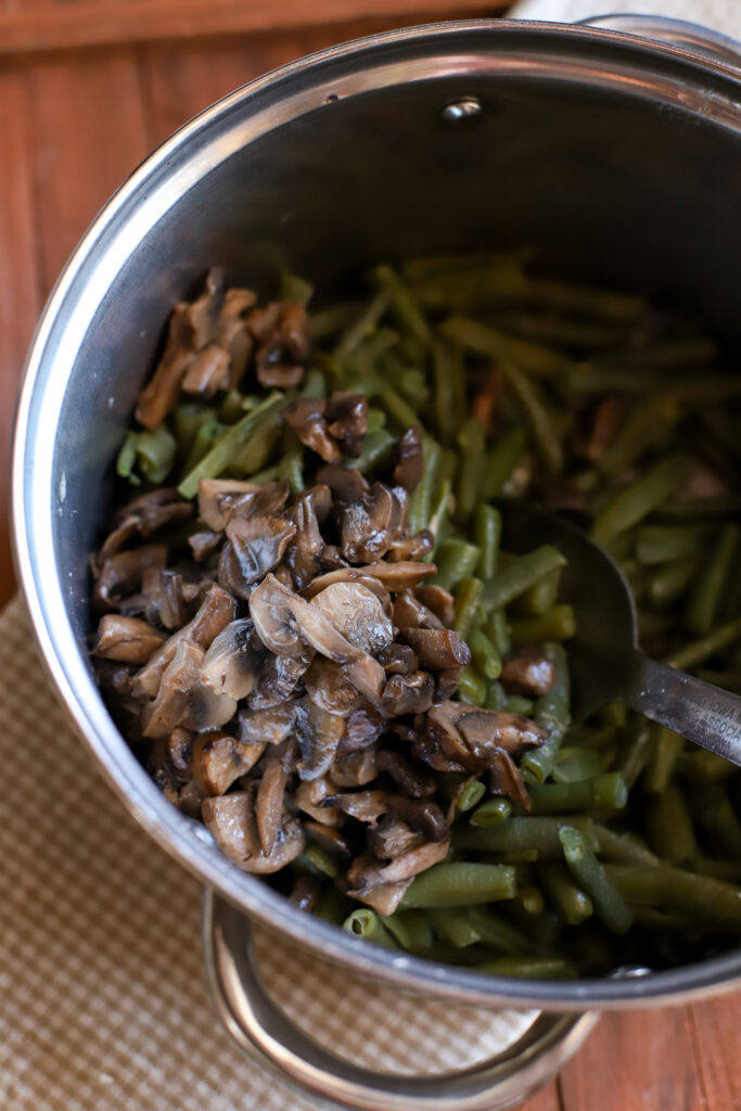 up close shot of sauteed mushrooms mixed into cooked frozen green beans