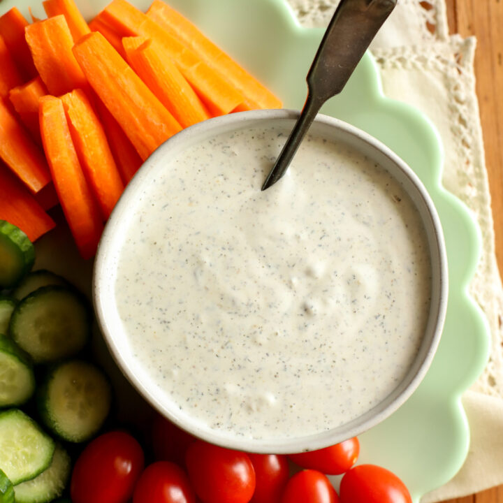 up close shot of a plate filled with vegetables and a bowl of homemade ranch dressing