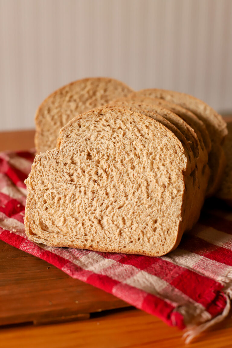 up close shot of slice of simple and soft fresh milled sourdough sandwich bread on a towel