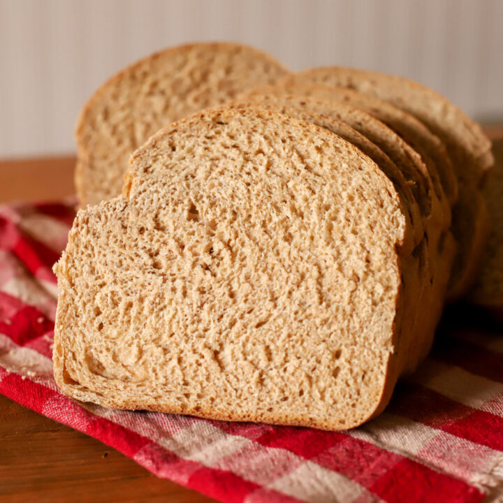 up close shot of slice of simple and soft fresh milled sourdough sandwich bread on a towel