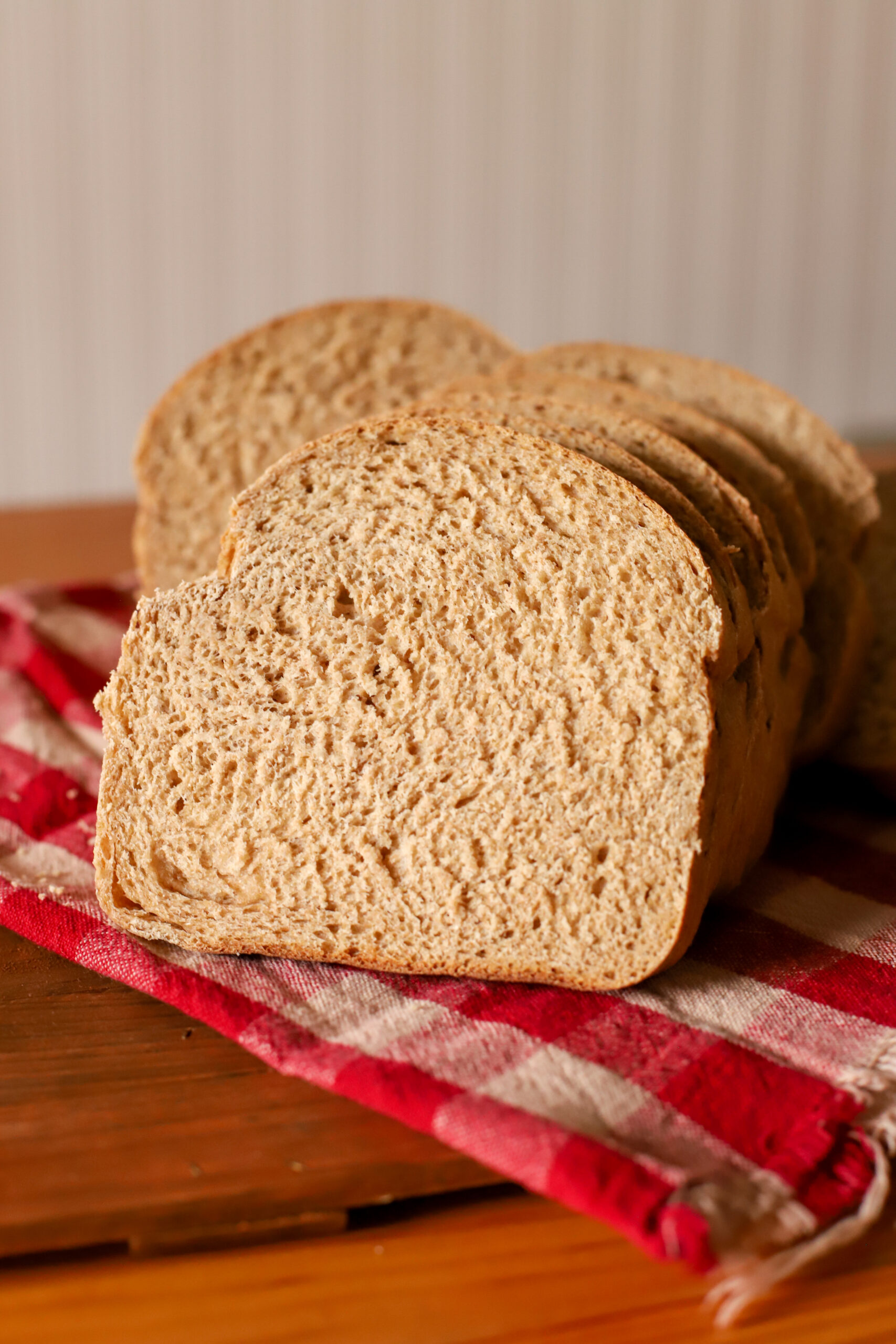 up close shot of slice of simple and soft fresh milled sourdough sandwich bread on a towel