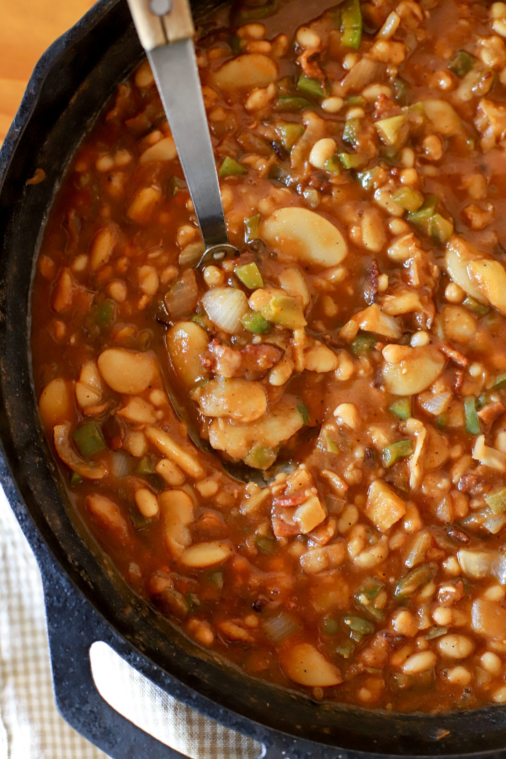 up close shot of a cast iron pan with homemade baked beans