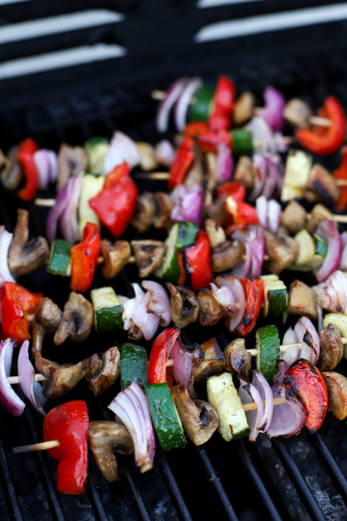 up close shot of cooked vegetable skewers with marinade on the grill