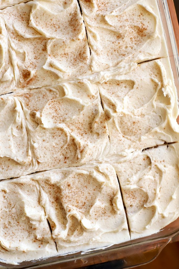 an up close overhead shot of a frosted fresh milled apple cake